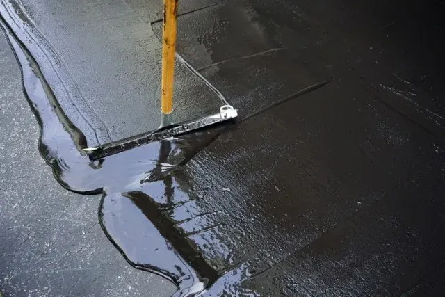 Sealcoat over cured asphalt and compacted base
